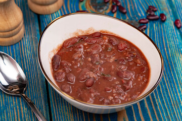 Healthy bean soup with red beans, Homemade Soup on blue wooden background , Vegetarian Food.