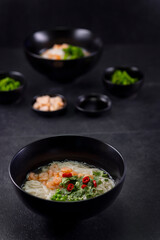 Various dishes of Asian cuisine with different types noodles and rice with shrimp, duck, vegetables and black sesame