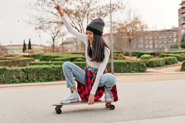 Young athlete riding a skateboard on the road. leisure and sport concept