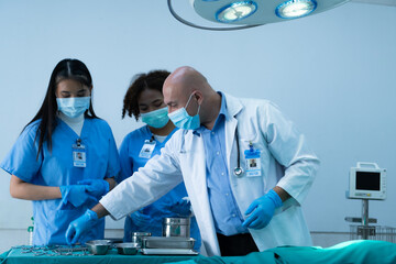 A medical professor is teaching surgery to medical students working