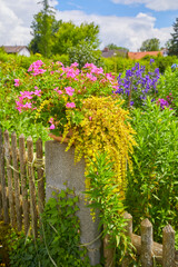 Beautifully maintained farmhouse garden with colorful flowers, in Bavaria, Southern Germany.
