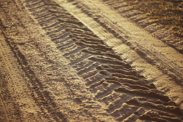 Tread pattern of a truck tire in soft sand. Tire` tracks printed in the sand