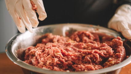 woman preparing meat dough