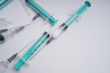 medical disposable syringe with needle for injection in the hospital. medical devices on a white...
