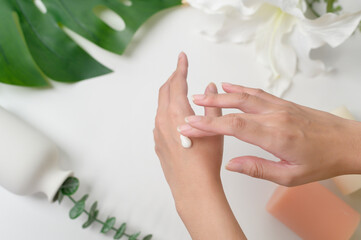 close up hand of applying moisturizing cream, skincare and beauty concept