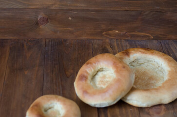 uzbek flatbread white bread is broken into pieces crumbs on a brown background illustration