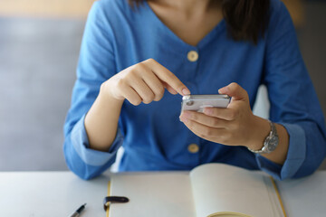 Woman using mobile phone to send text , work or play social media.