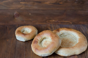 uzbek flatbread white bread is broken into pieces crumbs on a brown background illustration