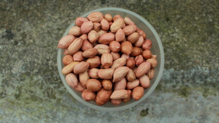 Salted Roasted Peanuts, Peeled raw peanuts are in a plastic cup, Healthy content, Copy space, top view.