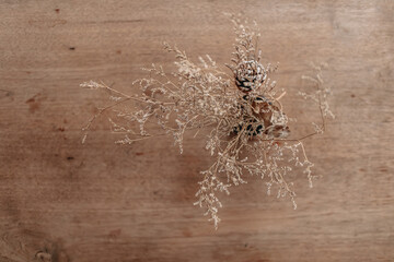 Top view of brown dried flowers decorated on wooden table.