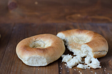 uzbek flatbread white bread is broken into pieces crumbs on a brown background illustration