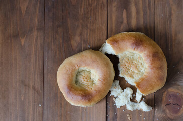 uzbek flatbread white bread is broken into pieces crumbs on a brown background illustration