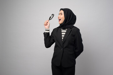 Muslim business woman holding Magnifier isolated on white background