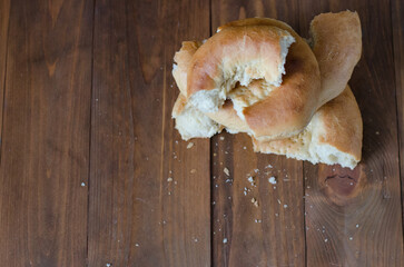 uzbek flatbread white bread is broken into pieces crumbs on a brown background illustration