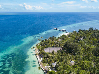 Aerial view of a beautiful resort on a tropical island in Indonesia. Indonesia has thousands of idyllic islands surrounded by coral reefs.