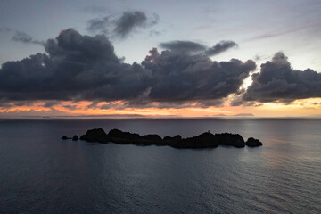 A calm dawn silhouettes beautiful limestone islands in Raja Ampat, Indonesia. This remote, tropical region is known as the heart of the Coral Triangle due to its extraordinary marine biodiversity.