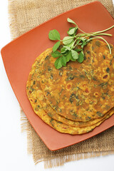 Indian flat bread,Methi Paratha,an Indian flatbread stuffed with fenugreek leaves and spices served with yogurt in breakfast or brunch 