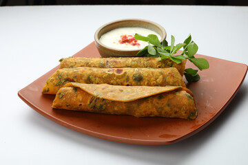 Indian flat bread,Methi Paratha,an Indian flatbread stuffed with fenugreek leaves and spices served with yogurt in breakfast or brunch 
