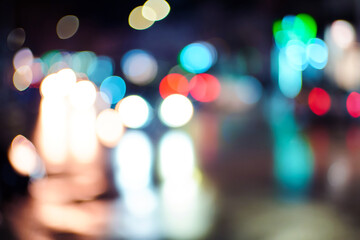 Fototapeta premium Colorful defocused background of car headlights on the street
