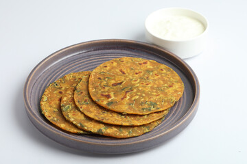 Indian flat bread,Methi Paratha,an Indian flatbread stuffed with fenugreek leaves and spices served with yogurt in breakfast or brunch 