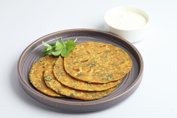 Indian flat bread,Methi Paratha,an Indian flatbread stuffed with fenugreek leaves and spices served with yogurt in breakfast or brunch 