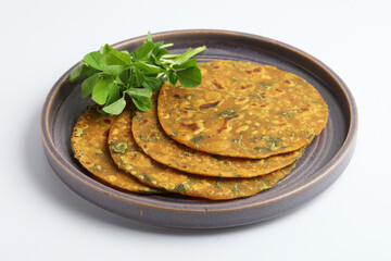 Indian flat bread,Methi Paratha,an Indian flatbread stuffed with fenugreek leaves and spices served with yogurt in breakfast or brunch 