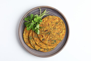 Indian flat bread,Methi Paratha,an Indian flatbread stuffed with fenugreek leaves and spices served with yogurt in breakfast or brunch 