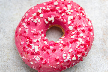 donut pink icing sweet dessert fresh portion healthy meal food diet snack on the table copy space food background rustic top view