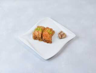 Traditional arabic and turkish sweets pastry dessert kadaif with pistachio. 