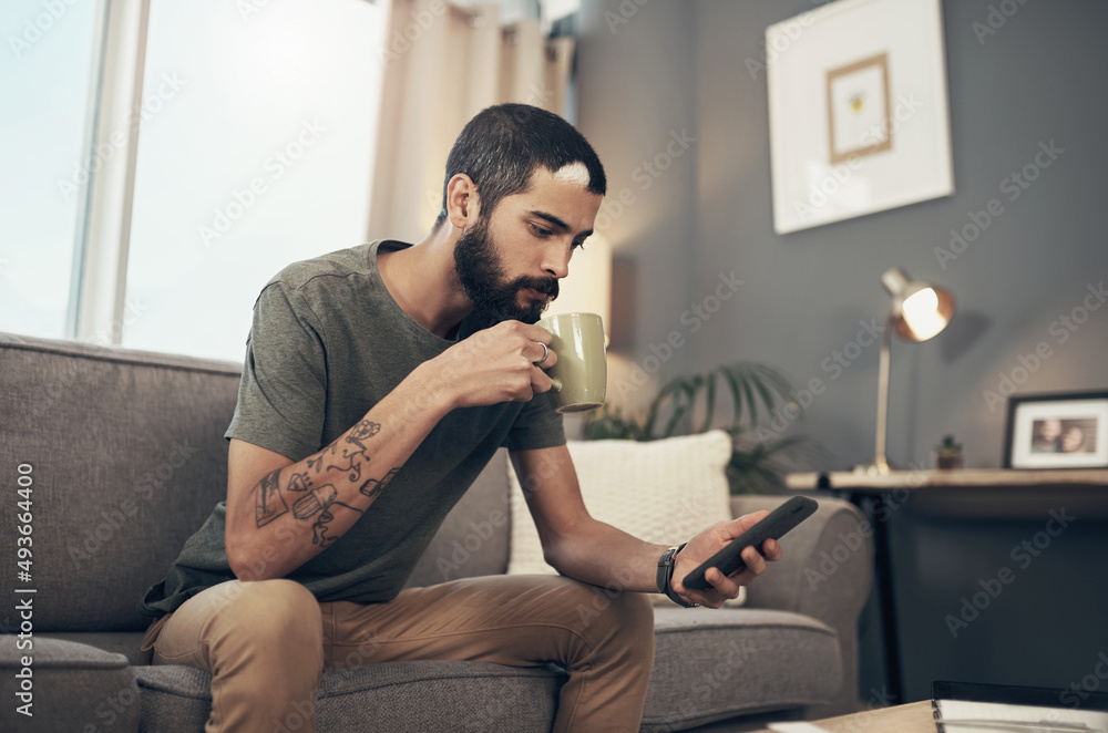 Aufkleber connect to all things current with the ease of technology. shot of a young man having coffee and usi