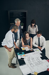 Shes got something to show them. High angle shot of a group of businesspeople meeting in the boardroom.