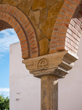 Arabic-style column and arches in the center of Mojacar, Almeria, Andalusia, Spain; showing the traditional Indalo symbol