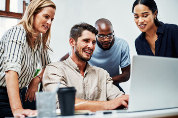Theyre impressed with his progress. Cropped shot of an attractive businesswoman helping a female colleague in the office.