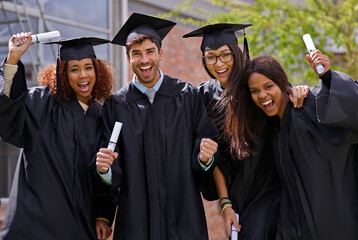Ecstatic education success. Shot of excited university students on graduation day.