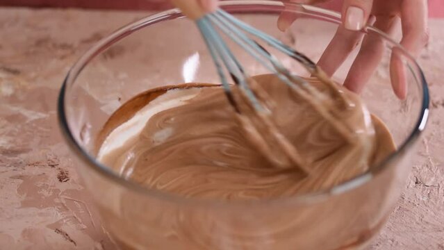 Woman making delicious chocolate cream, close-up.