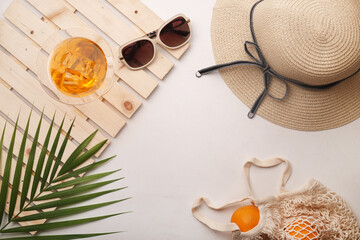 Summer flat lay mockup. Summer season props like hat, goggles, oranges, juice kept around on yellow background. © Munchy Pixels