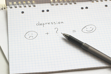 a paper with hand drawn emotions sad and smile, depression and happiness