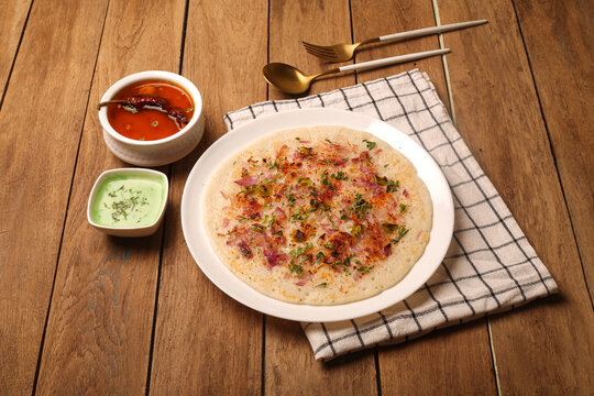 Onion uttapam south Indian dish. With sambhar and green coconut chutney.