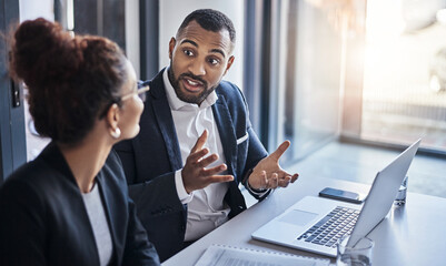 This is how we will manage the plan. Shot of two businesspeople having a discussion in an office. - Powered by Adobe