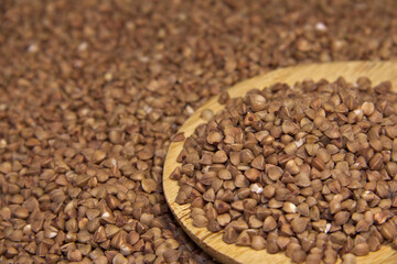 Wooden spatula in buckwheat. Macro. Angle angle.