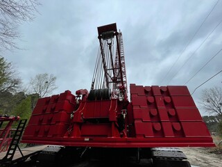 Manitowoc Red Crane Construction scene cloudy rainy day back view weights