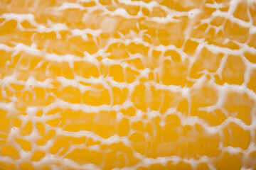 White cream smear textured background on yellow background