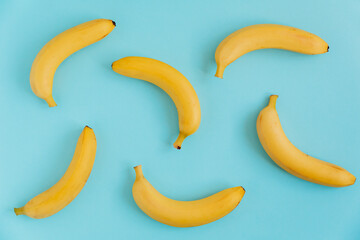 Fresh bananas on a blue background. Flat lay. Fruit background. Food pattern