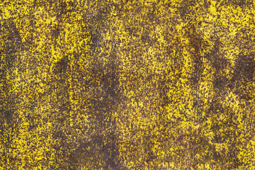 Brown abstract background with acid yellow green red hues. A rust-eaten textured sheet of metal with remnants of paint marks.
