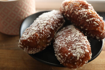 Traditional Sunday morning snack. Coconut covered doughnuts or koesister. Cape Malay cooking....