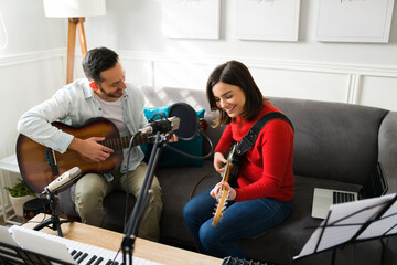 Cheerful duo enjoying playing instruments