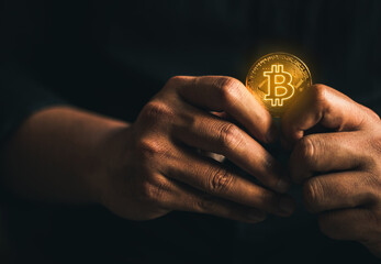 cryptocurrency golden bitcion. hand holding gold bitcoin - virtual Btc neon sign for trading web  and international network payment.