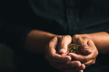 cryptocurrency golden bitcion. hand holding gold bitcoin - virtual Btc neon sign for trading web  and international network payment.