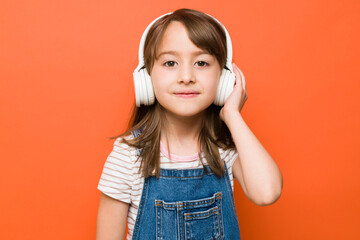 Cute girl wearing wireless headphones