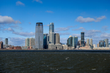 Views of Battery Park and the financial district from the water and Ellis Island in New York City